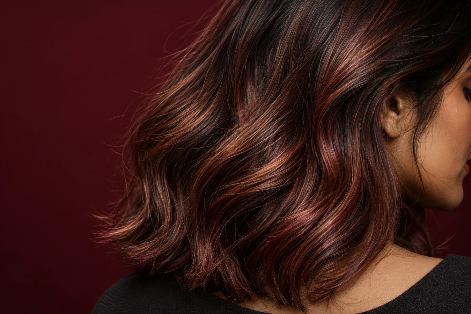 Dimensional brunette, copper and cherry hair colour in an illustrative Supreme Salon editorial study